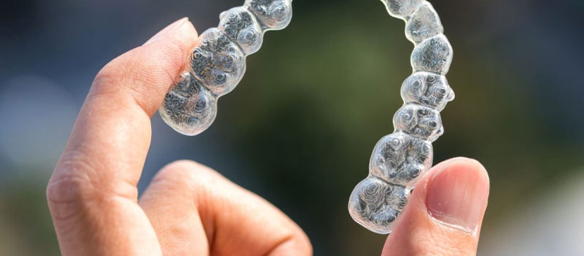 Invisalign Model Being Held Up